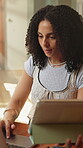 Laptop, remote work and tablet with woman in home for planning, research or review. App, compare and technology with with freelance employee at desk in apartment for agenda or online schedule