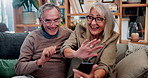 Phone, wave and old couple in home with video call, bonding together or hello for online communication. Happy, senior married people and greeting on couch with tech, virtual contact and conversation.