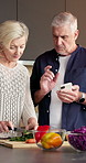 Vegetables, cooking and old couple with phone, chopping board and organic recipe in kitchen. Mobile, senior people and meal prep with help, cut ingredients or online tutorial for healthy diet at home