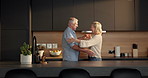 Love, dance and senior couple in kitchen, romantic moment and weekend bonding for healthy relationship. Trust , smile and elderly people with music for support, connection and moving together in home
