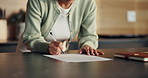 Woman, hands and signature with document in kitchen for finance, investment policy or application. Female person, writing or signing with paper on counter for financial insurance or agreement in home