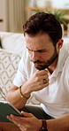 Thinking, tablet and man on sofa in home for reading blog on saving, investment or finance tips. Planning, digital technology and person in living room for website on financial growth with advice app
