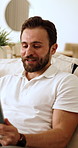 Video call, tablet and man on sofa in home for communication, contact or networking. Happy, digital technology and male person in living room for virtual conversation for advice in apartment.