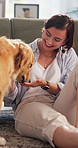 Feed, happy woman and dog with snack in home for pet training, adoption and loyal companion. Food, owner and golden retriever with treat in living room for animal care, canine rescue and connection