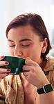 Happy, thoughtful and woman with coffee on sofa for wellness, calm and peaceful on weekend morning. Home, thinking and person with drink for reflection, inspiration and good mood in living room