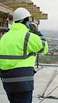 Back, man and engineer at site with phone call, inspection and planning for architecture. Person, walking and discussion on rooftop with mobile, quality assurance and feedback on building development