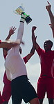Outdoor, sport and team with trophy for celebration, soccer tournament and excited for match success. Low angle, happy men or football players with jump for victory cup, competition winner or yelling