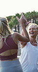 Fitness, women and high five in city, laugh and endurance achievement on break with partner. Funny friends, runners and celebration outdoor for cardio success, exercise support and goal on bridge