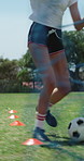 Woman, legs and soccer ball on field for training, cardio exercise and practice technique to score goal. Athlete, person and football player outdoor for running drill, sports performance and workout.