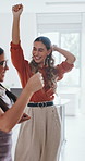 Happy, dancing and business women in office with good news, achievement or collaboration goal. Smile, music and team of female creative designers with groove for bonus, job promotion or winning.