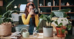 Gardening, woman and plant photography in house for houseplant trade blog, online post or happy. Camera, indoor gardener and filming leaves in home to share growth progress, web sale or social media