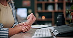 Woman, laptop and hands with wrist pain in home for overworked strain, pressure or sprain. Female person, sore arm or carpal tunnel syndrome on computer for muscle tension or joint inflammation