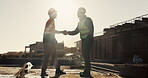 Construction, greeting or people on site with handshake, deal or meeting for contractor partnership. Team, flare or engineers with shaking hands, agreement or opportunity for industrial collaboration