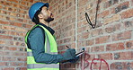 Clipboard, inspection and man with wire at construction site, compliance officer or infrastructure. Writing, evaluation and person with checklist for process, installation or electrical line review