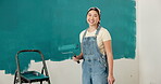 Face, painting and woman at house with wall, interior design and diy project for renovation. Portrait, female person and paintbrush in home for remodeling, property makeover and household improvement