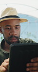 Greenhouse, research and man with tablet, agriculture and crop management on web and sustainability. Black person, online and monitor climate for plant growth, scroll and inspection with tech in farm