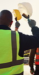 Hardhat, men and construction workers on site with celebration for building, repairs or maintenance. Helmet, professional and civil engineers with good news on industrial project outdoor by flare.