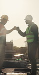 Celebration, team or men with fist bump at construction site, development milestone or foundation done. Space, support or people with inspection of labor, infrastructure progress or property building