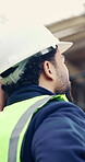 Back, hard hat and thinking with man on construction site for engineering or property development. Architecture, helmet and inspiration with building professional outdoor for planning or vision