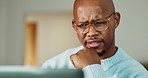 Confused, laptop and black man in home with remote work for mistake on coding project with thinking. Plan, computer and software engineer with research on website development with glitch in house.