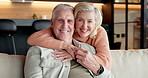 Hug, face and old couple in home with love, connection and care with relationship security. Living room, happy man and woman embrace on sofa for trust, support and commitment to partner in retirement