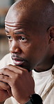 Thinking, decision and black man in home with mistake, pressure or anxiety for unemployment. Stress, doubt and African male person in living room with reflection, bad news or job loss in house.