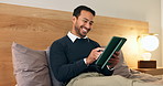 Happy, businessman and bed with tablet in home for social media, network or online connection. Man, smile and relax with technology in bedroom for streaming app, entertainment or humor in house