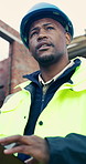 Architect, thinking and man with tablet at construction site, smile and planning for home renovation. Civil engineer, outdoor and happy person with tech, low angle and ideas for property development
