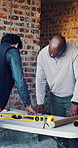 Architect, men and talk with blueprint on site for design vision, building layout and compliance. Construction, architecture meeting and team with floor plan for structural review, progress or safety