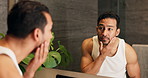 Mirror, man and beard care in bathroom for beauty, grooming and check skin with morning routine. Reflection, home and person with inspection for facial hair, cosmetics and skincare for wellness