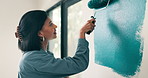 Woman, smile and painting with roller for home renovation, interior design and property upgrade. Happy, creative person and art tools with diy project for house improvement, remodeling or maintenance