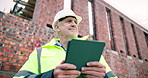 Engineer, thinking and construction outdoor with tablet, labor regulations or check safety compliance. Low angle, mature man and PPE on site with tech, engineering report or infrastructure management