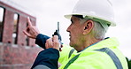Planning, man and radio on construction site for task brief, inspection or safety update. Industrial, communication and mature engineer with tech, progress report or project coordination for feedback
