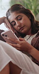 Sad, message and woman in house with phone, upset text or breakup in online communication. Unhappy, hurt and female person in lounge with tech, emotional chat or heartbreak response on dating site.