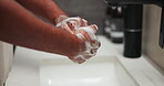 Basin, foam and washing hands with person in bathroom for grooming, hygiene or skincare routine. Cleaning, soap and wellness with man at sink in home to remove bacteria or germs for disinfection