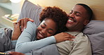 Couple, laughing and cuddle on bed, home and bonding with partner in bedroom, support and connection. Black people, smile and resting with spouse in house, embrace and commitment for relationship