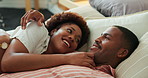 Happy couple, talk and cuddle on bed, home and bonding with partner in bedroom, love and connection. Black people, smile and resting with spouse in house, discussion and commitment for relationship