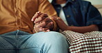 Couple, holding hands and support in lounge, home and bonding with partner on weekend or connection. People, love and commitment for relationship, loyalty and solidarity with spouse in living room