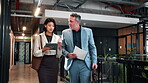 Office, team and walk with tablet, research and financial forecasting with report or info on website. Economist, collaboration and people with tech, brainstorming and business strategy with paperwork
