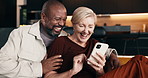 Mature, couple and laugh in home with phone, funny social media video and bonding together on weekend. Happy, interracial marriage and people on couch with tech, discussion and humor for online meme.