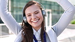 Face, dancing and happy woman with headphones in city for music, podcast or audio streaming. Portrait, female person or listening with smile, vibe or energy for sound app or playlist in an urban town