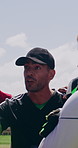 Sports, talking and coach with men on field for practice, training and prepare for competition. Soccer, team and people with strategy, huddle and instructions for match, tournament and game outdoor