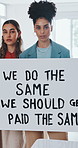 Face, women and poster in business for gender equality, empowerment and protest sign for wage gap. Serious, female people and feminism in office for equity, unity or support movement for fair payment