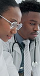 Discussion, black people and doctors at hospital in collaboration for surgery or medical treatment. Conversation, team and African healthcare workers with schedule planning together in clinic.