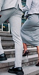 Stairs, walking and business people in city for commute, travel and trip to financial agency. Corporate, team and woman with man in discussion for journey, meeting and proposal update in town