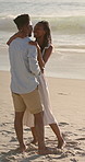 Holiday, dancing and couple with kiss on beach for bonding, summer trip and travel for connection. Affection, happy and black people with tropical vacation for romance, love or moving together by sea