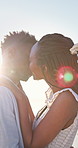 Couple, hug and kiss on holiday, romance and travel with partner on date or anniversary celebration. Outdoor, black people and embrace with spouse on special event, flare and support on vacation