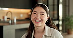 Asian woman, face and happy in home with laugh, relax and break on weekend in kitchen with confidence. Person, smile and funny in portrait with pride, chill or day off at apartment in Indonesia