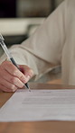 Creative, signature and hand with contract in home, remote work and approve exclusive author rights. Freelance, writer and person with legal document in house, writing and commission approval on desk