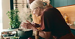 Smell, cooking and interracial couple in home with support, love and meal prep with healthy food in kitchen. Mature, man and woman at stove with recipe, help and nutrition for diet or culinary skills